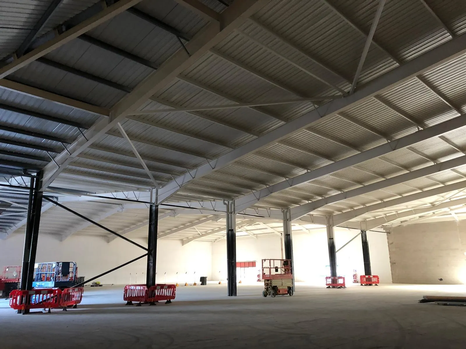 Painted roof steelwork in a large retail unit during fit-out