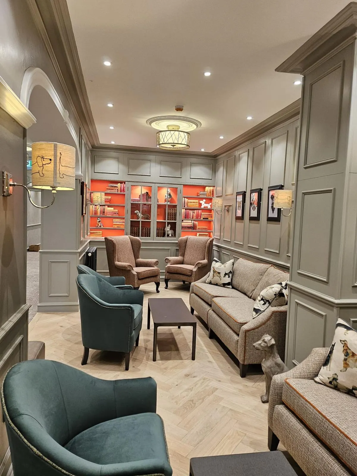 Panelled lounge with grey paintwork and an orange bookcase alcove