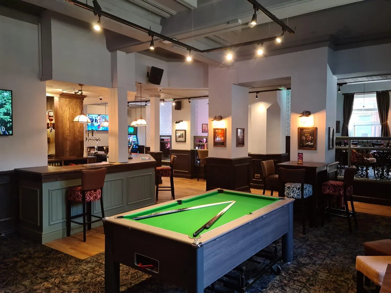 Pub games area with grey painted panelling