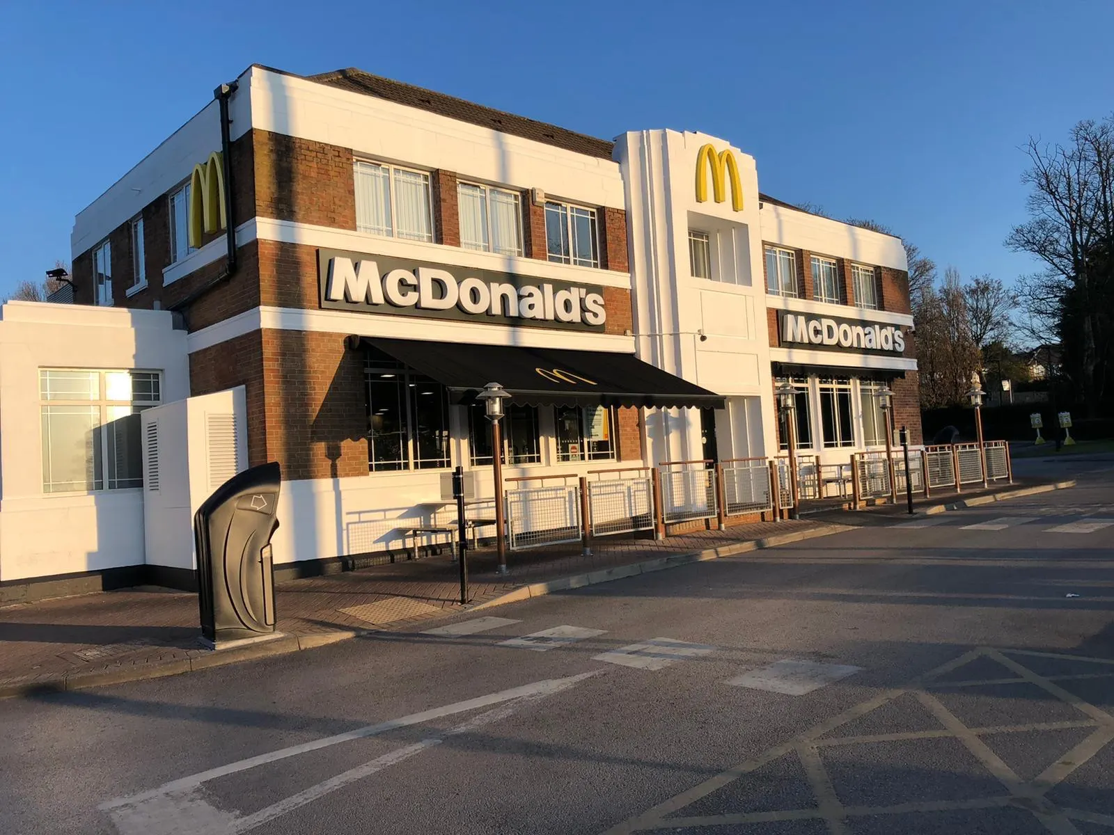 Refurbished restaurant exterior with white painted render and brickwork