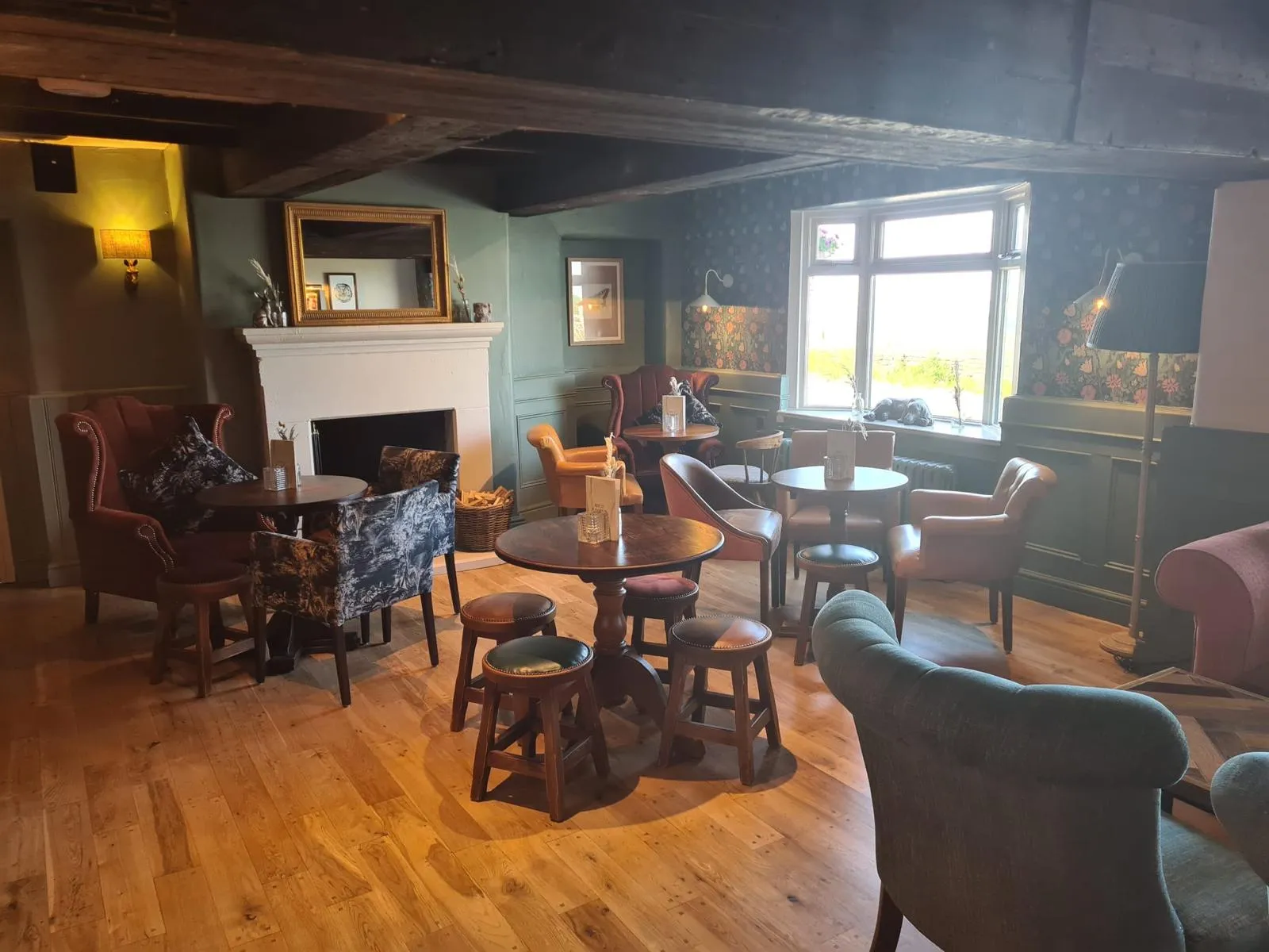 Pub lounge with fireplace, painted walls and wooden floor