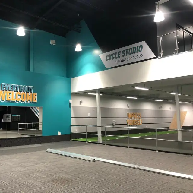 Gym interior decorated with teal and white feature walls