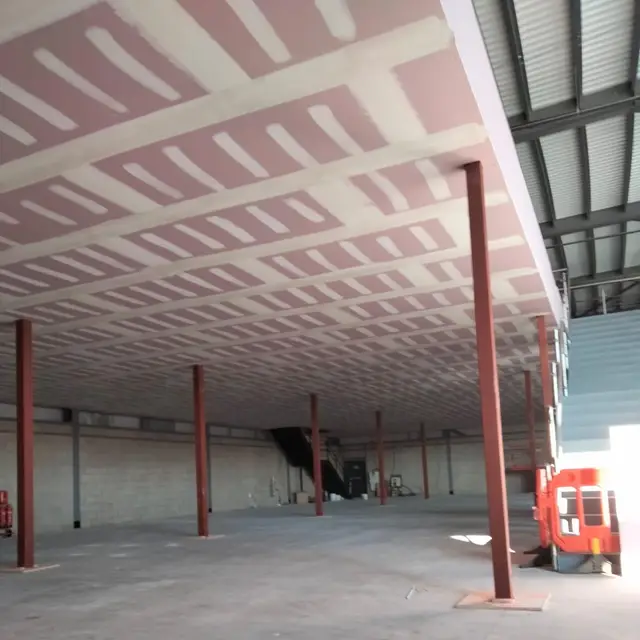 Commercial unit under refurbishment with painted steel columns and ceiling