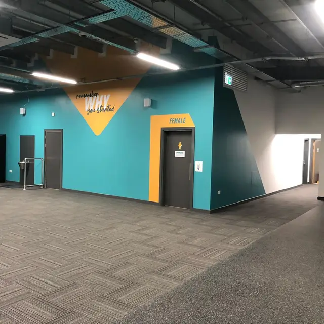 Gym corridor with teal and orange painted feature walls