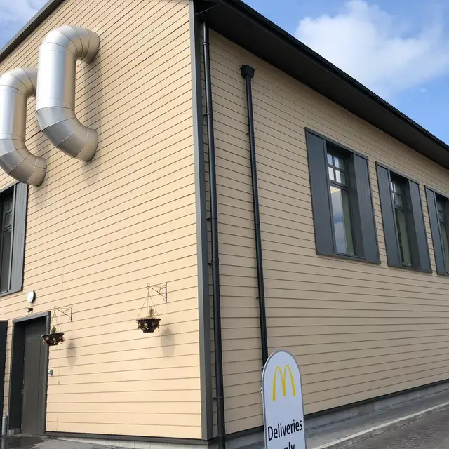 Side elevation of a drive-thru restaurant with painted cladding