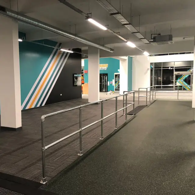 Gym ramp and training area with teal and white painted walls