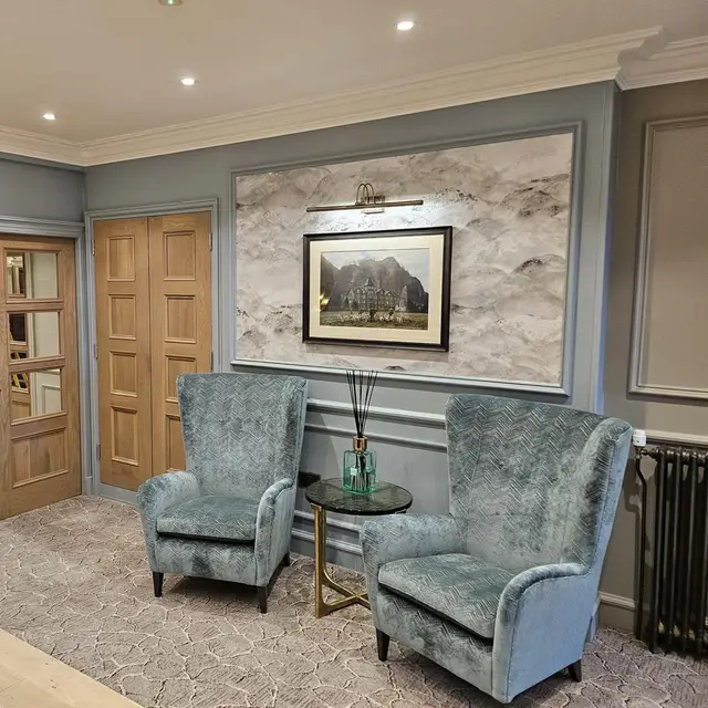 Seating area with grey painted wall panelling in a care home