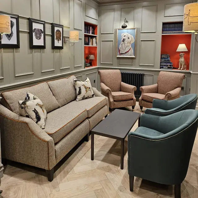 Care home lounge with grey panelled walls and orange feature shelving