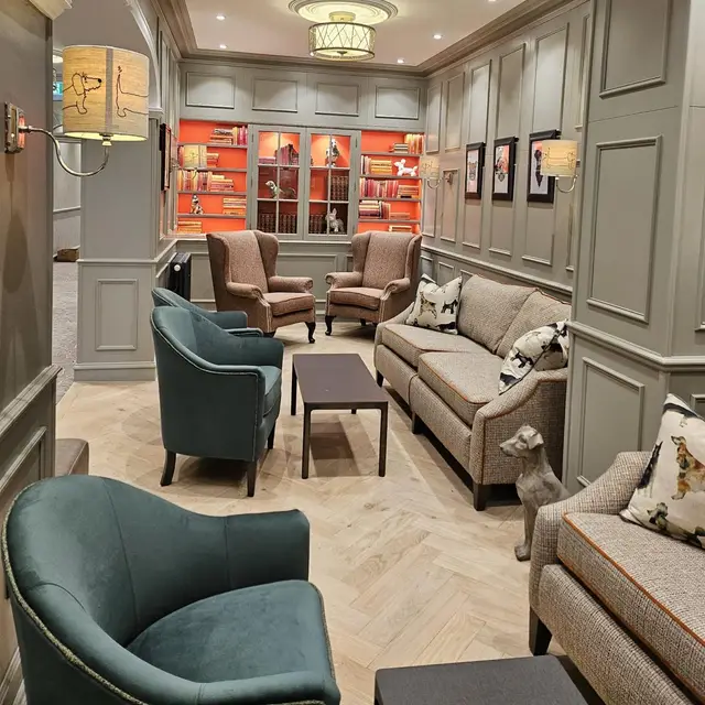 Panelled lounge with grey paintwork and an orange bookcase alcove