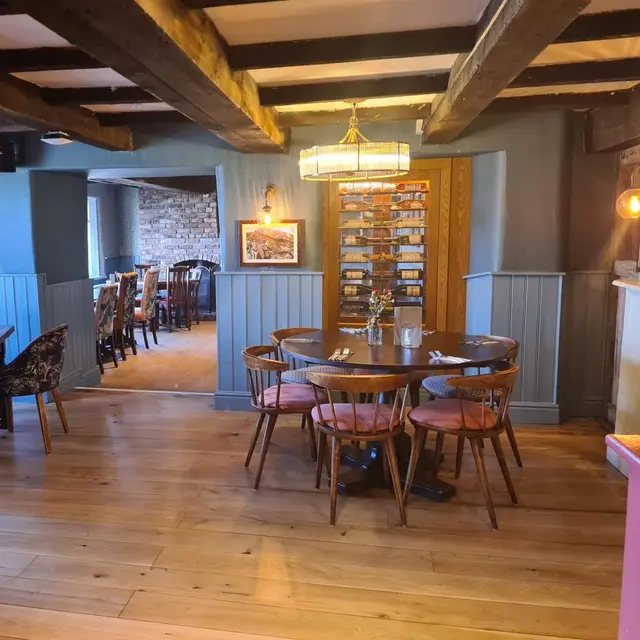 Pub dining area with blue painted panelling and exposed beams