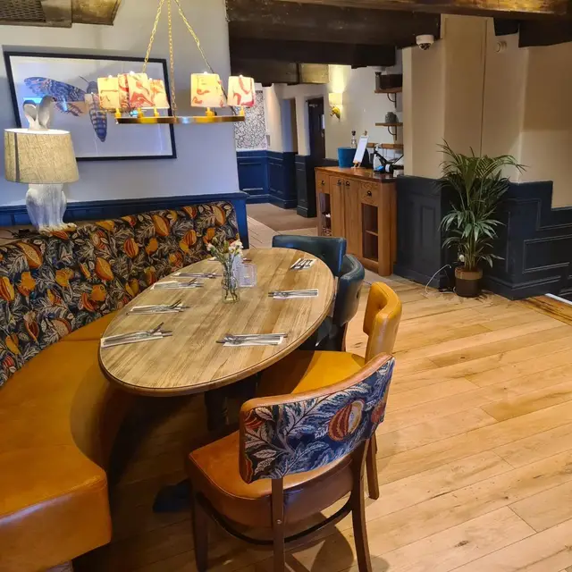 Pub dining booth with navy wall panelling and cream walls