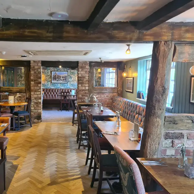 Pub interior with timber beams, exposed brick and parquet floor