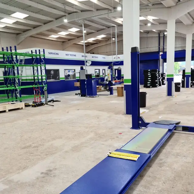Vehicle service centre workshop with painted walls and steelwork