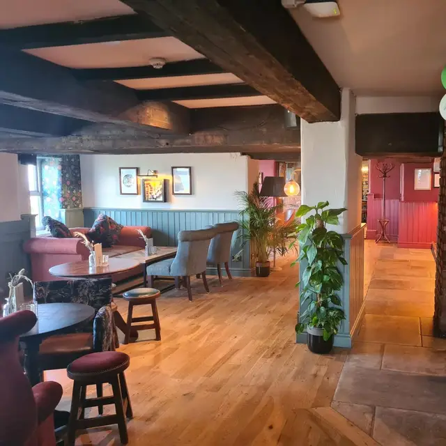 Pub bar area with exposed brick, beams and flagstone floor