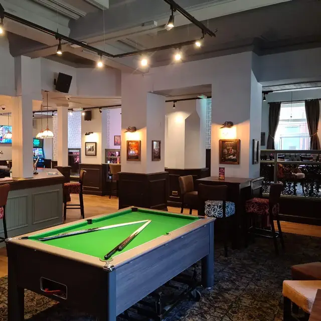 Pub games area with grey painted panelling and a pool table
