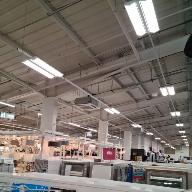 Retail store fit-out with painted ceiling services and shelving