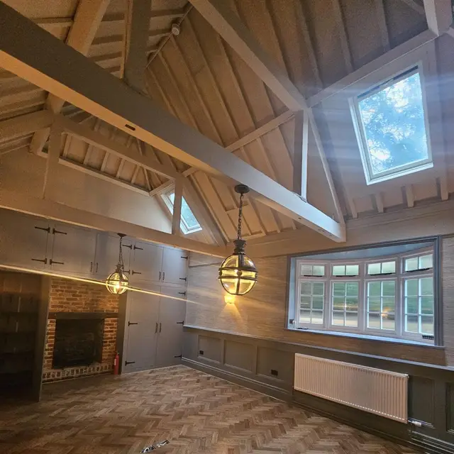 Vaulted room with painted timber panelling and parquet floor