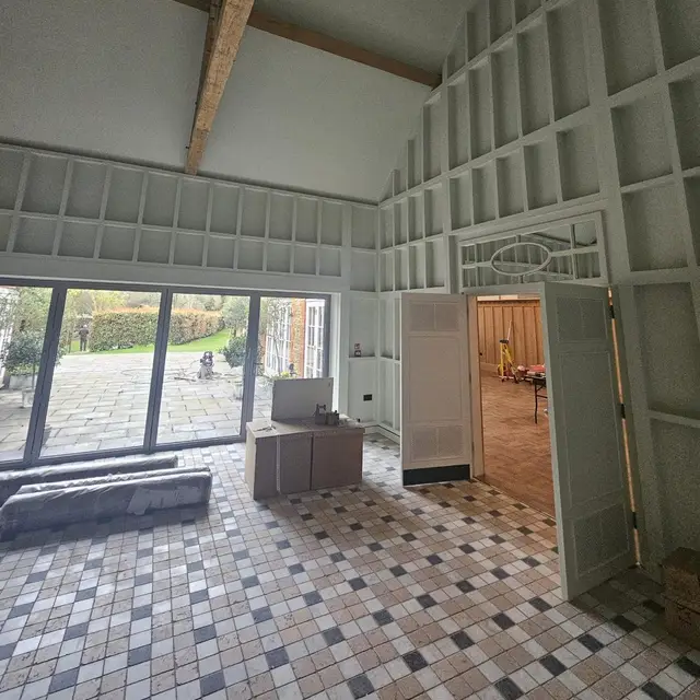 High-ceilinged room with grey painted wall panelling