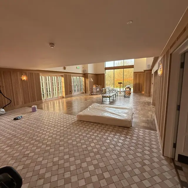 Long function room with timber panelled walls and tiled floor