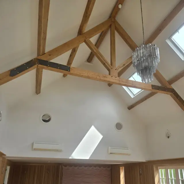 Vaulted function room with oak trusses, skylights and white walls