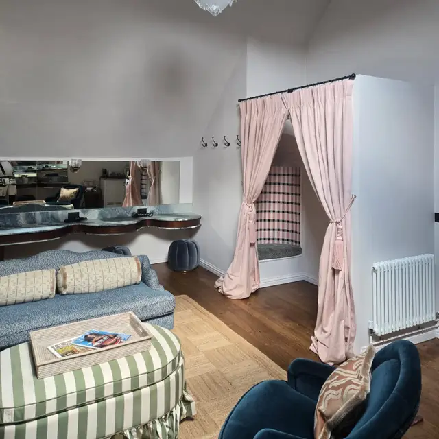 Bedroom suite with white painted walls and a chandelier