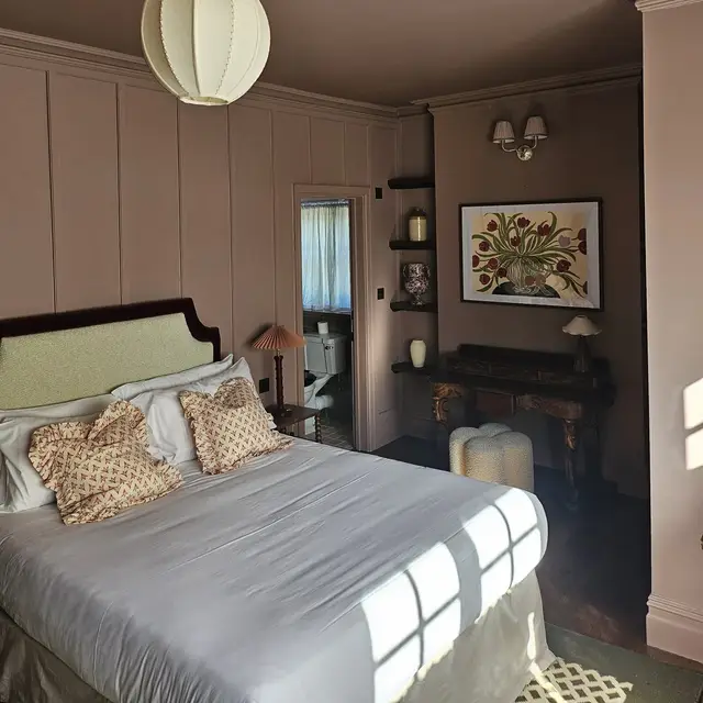 Bedroom with pink painted wall panelling