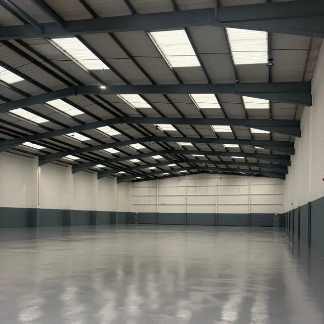 Large industrial unit with grey resin floor and painted walls