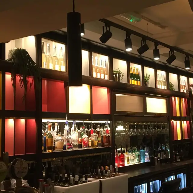 Back bar with coloured painted panels and shelving