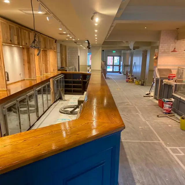Bar counter with blue painted panelling during refurbishment