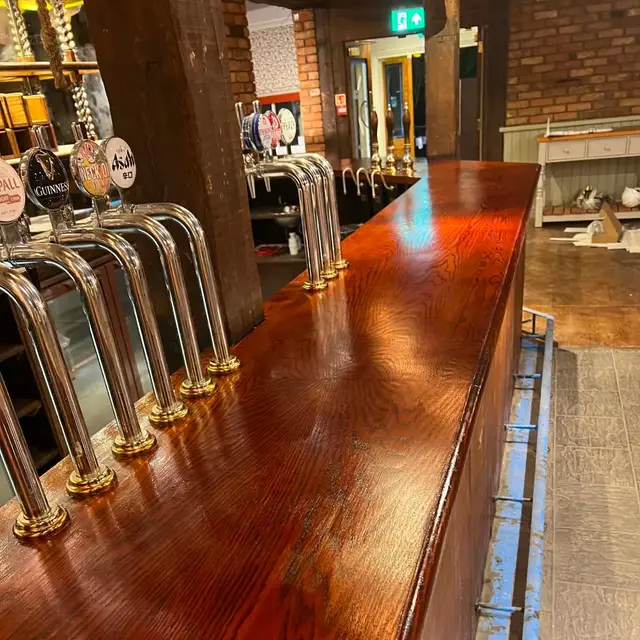 French polished mahogany bar counter with beer pumps