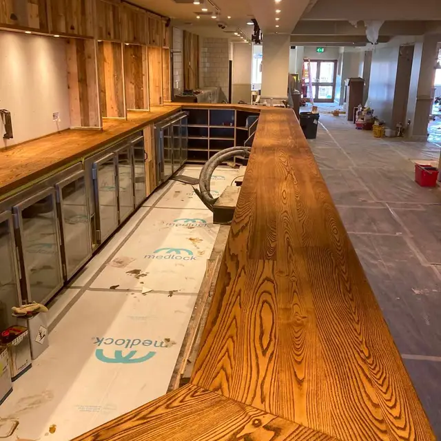 Refinished oak bar top during a bar refurbishment